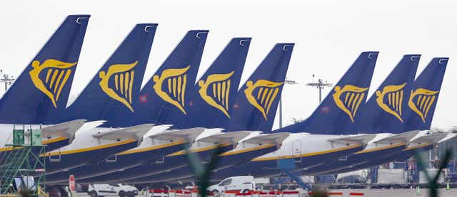 Ryanair jets parked up on the runway (PA)