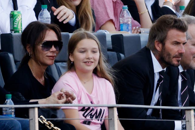 <p>Victoria Beckham sits with daughter Harper Beckham and husband David Beckham at a game between Inter Miami FC and the Los Angeles Galaxy on 18 April 2021</p>