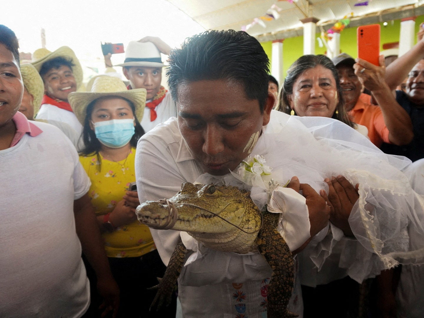 The mayor of San Pedro Huamelula kisses the alligator