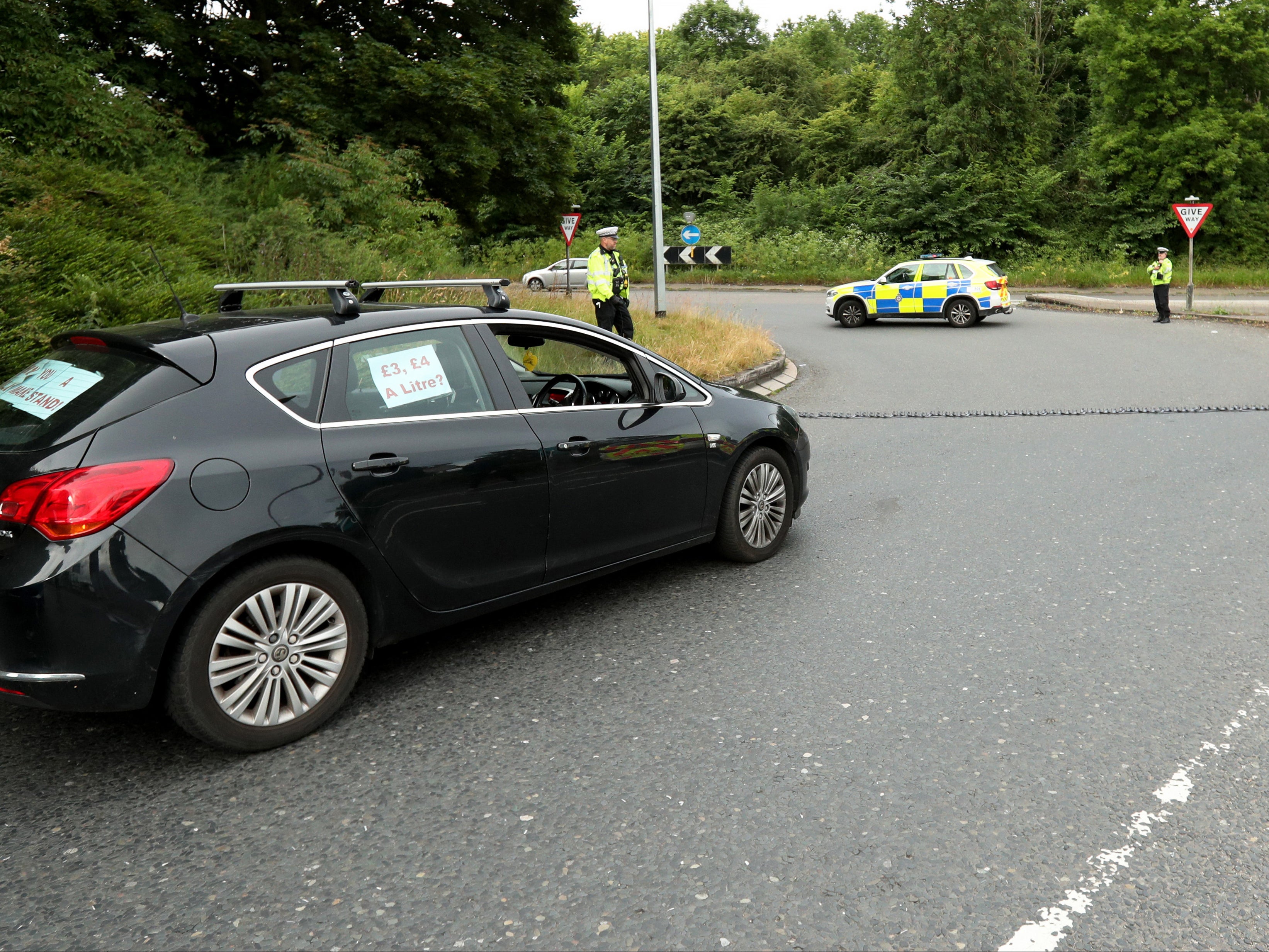 Police put down a stinger at the exit junction to the service station