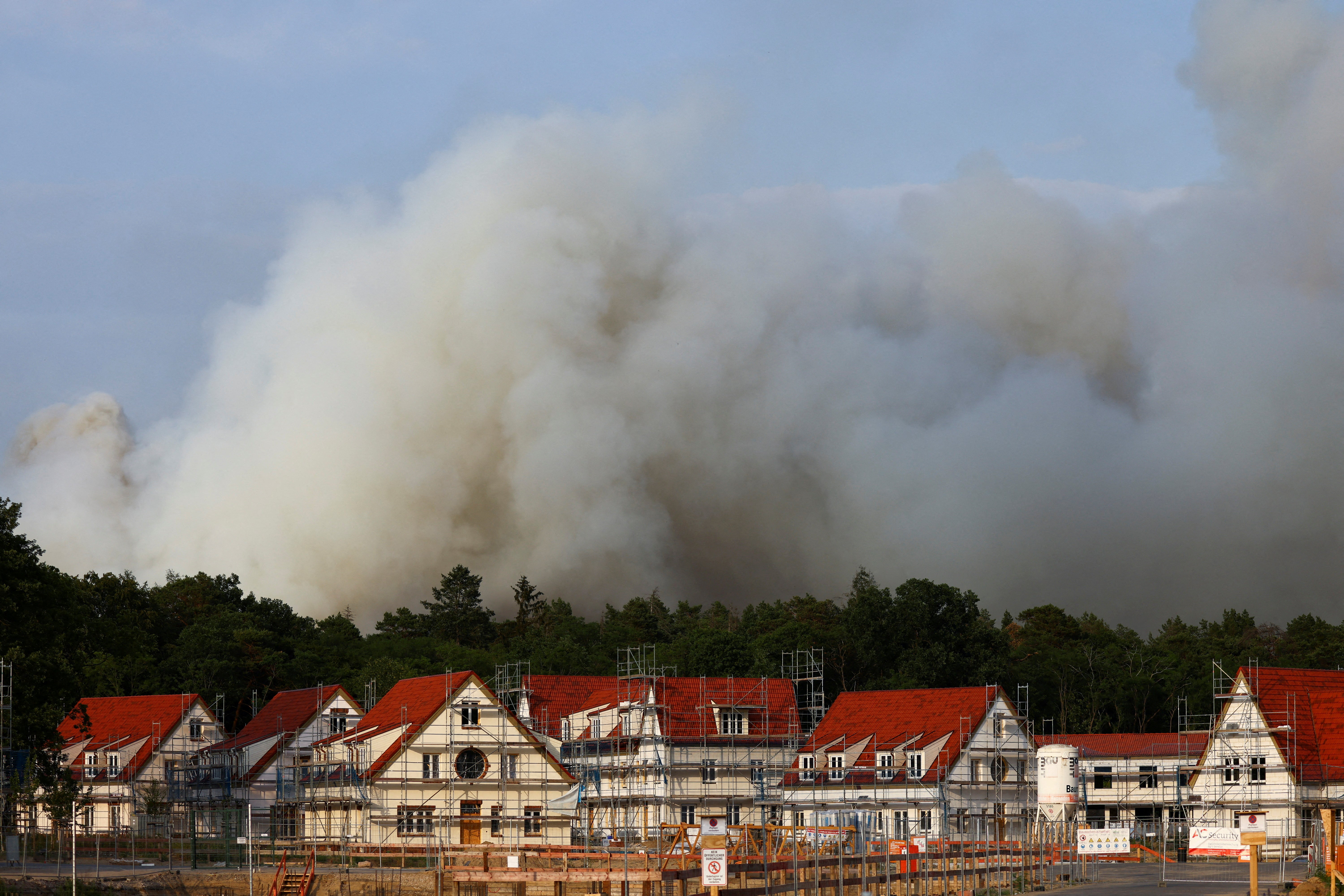 Smoke rises from a forest fire behind a construction site near Beelitz, south of Berlin, Germany, in June this year