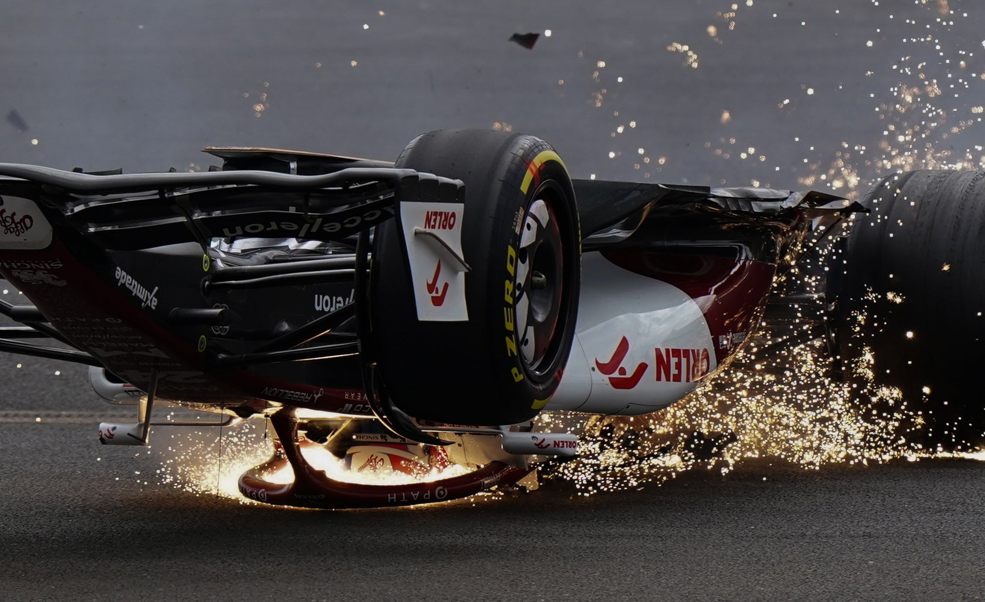 Alfa Romeo’s Zhou Guanyu slides towards the barrier after a collision at the start of the British Grand Prix (Tim Goode/PA)