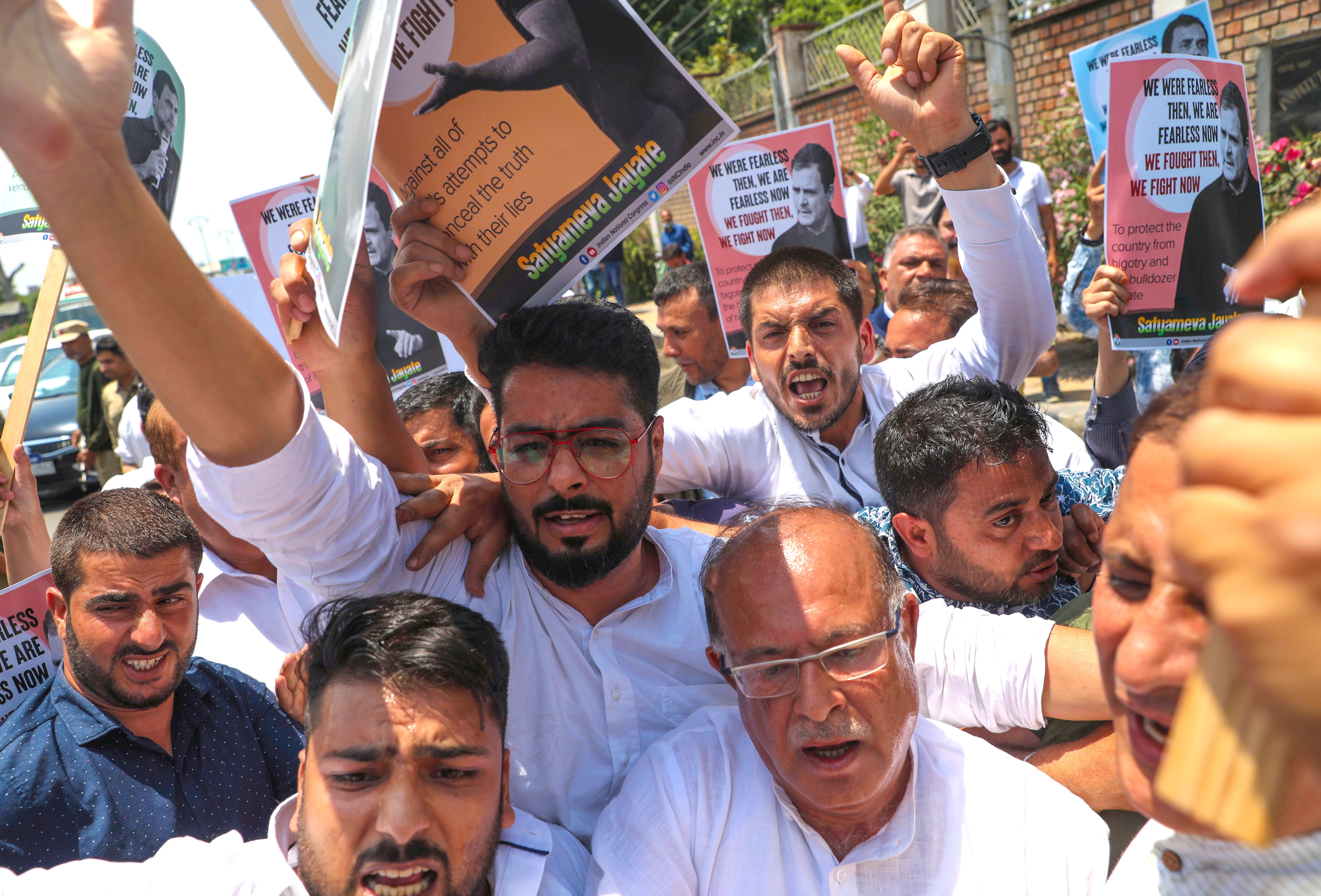 Kashmiri Congress (INC) leaders and activists shout slogans during a protest march