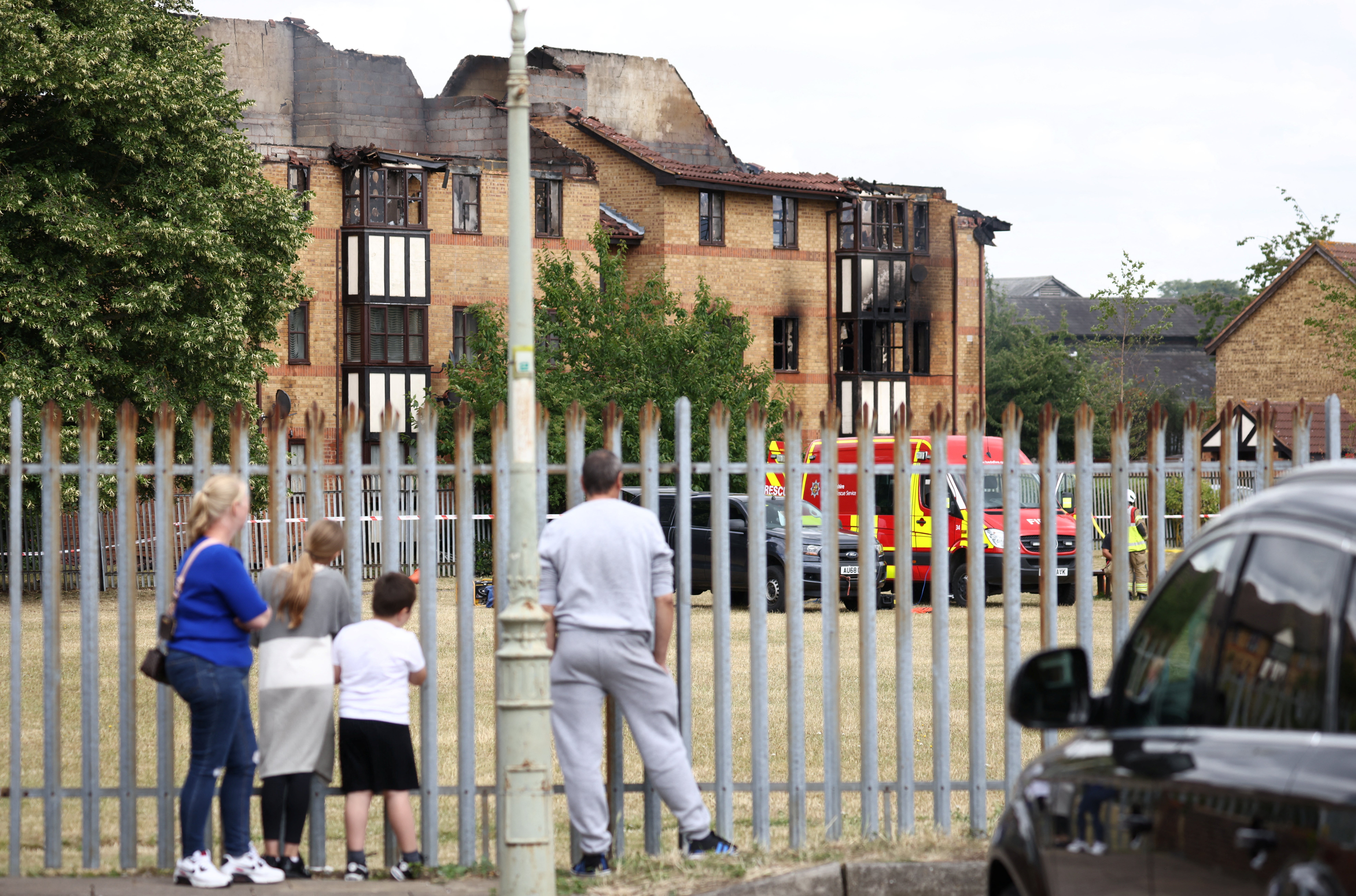 People watch the scene of a fire at Redwood Grove following a gas explosion