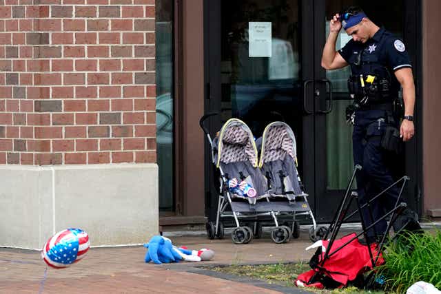 <p>Police on the scene of the mass shooting which unfolded as families were celebrating a July 4 parade </p>
