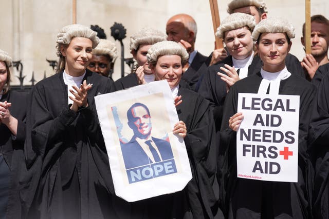 <p>Criminal defence barristers gather outside the Royal Courts of Justice in London (Kirsty O’Connor/PA)</p>
