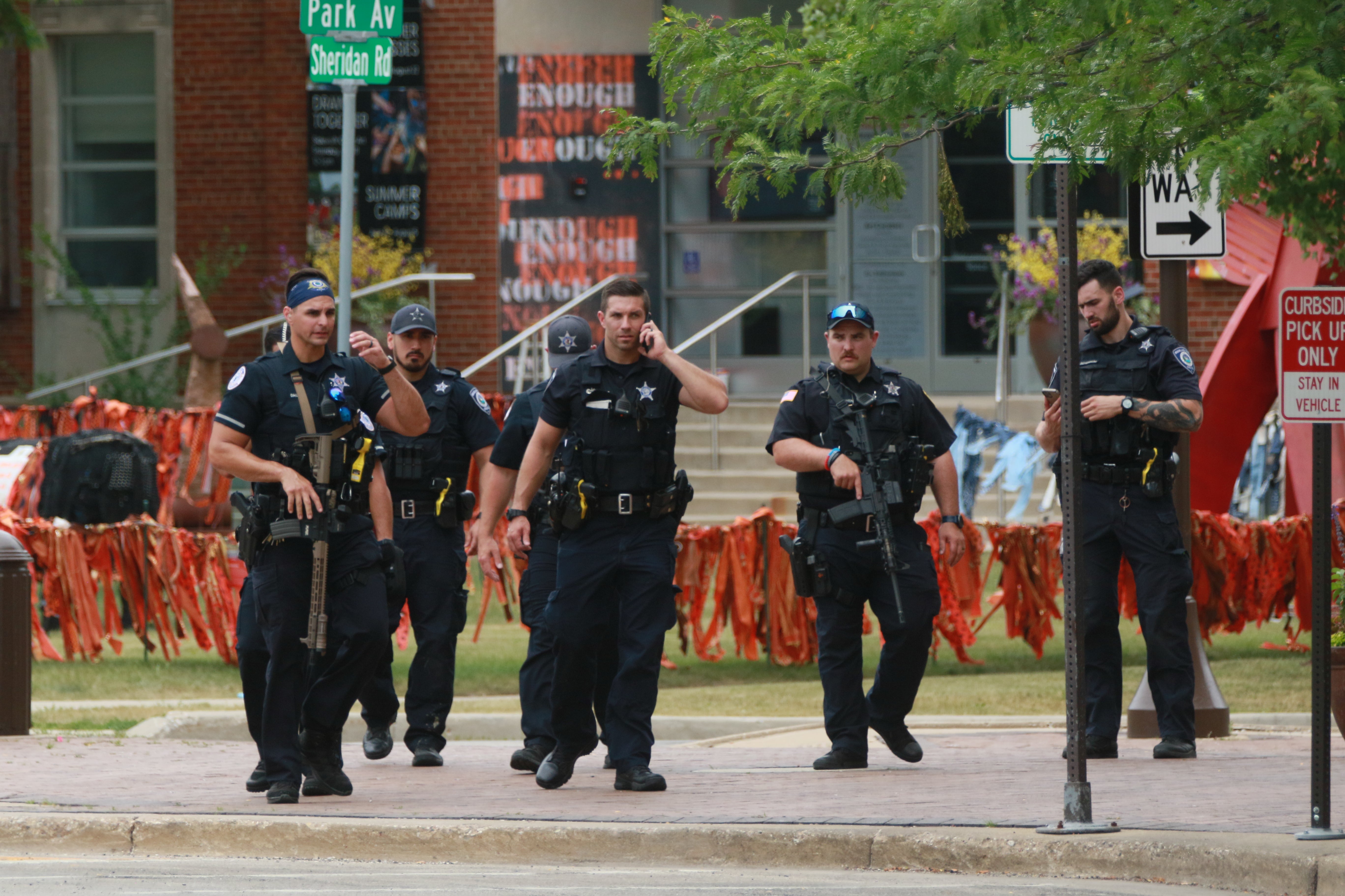 Law enforcement search the area of a shooting at a Fourth of July parade on 4 July 2022 in Highland Park, Illinois