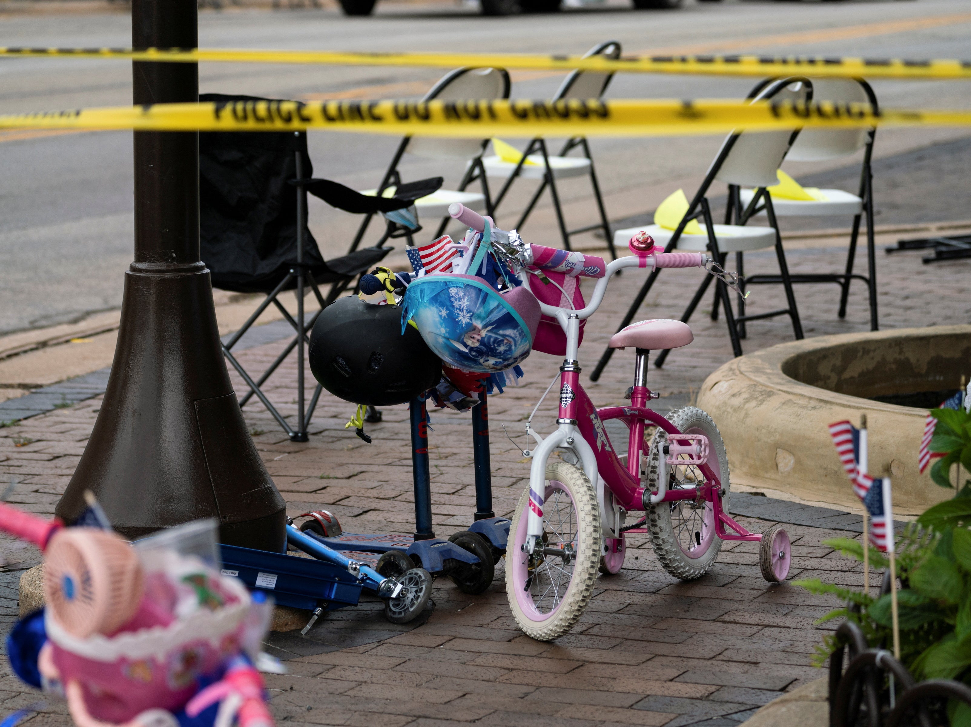 A child’s bike is left behind in the aftermath of the mass shooting in the wealthy Chicago suburb