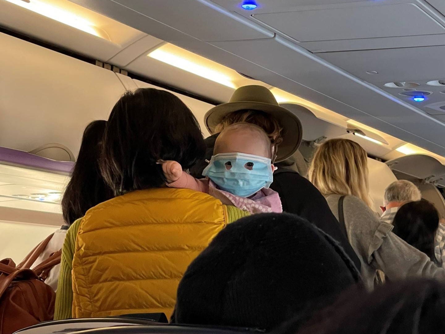 The infant could be seen looking through the make-shift eye holes of is face mask