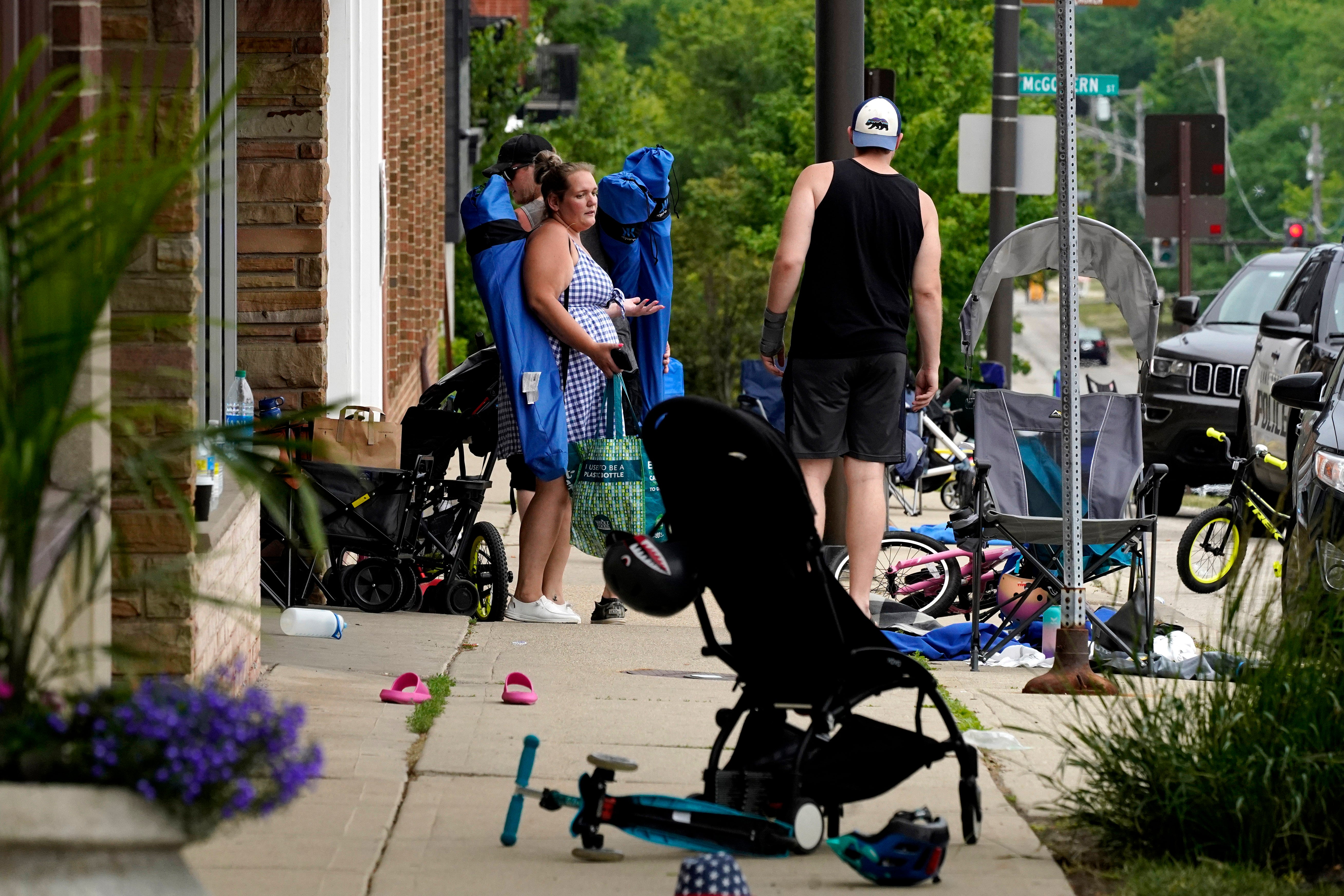 People return to their belongings in the aftermath of the shooting