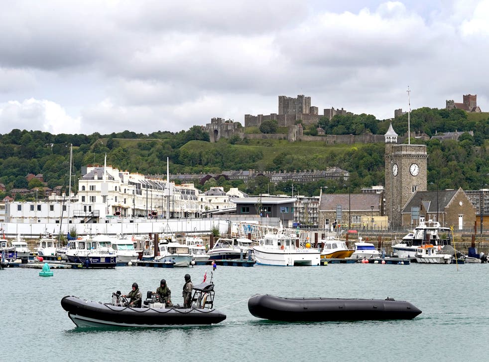 Military personnel tow a dinghy thought to be used by migrants in to Dover, Kent (Gareth Fuller/PA)