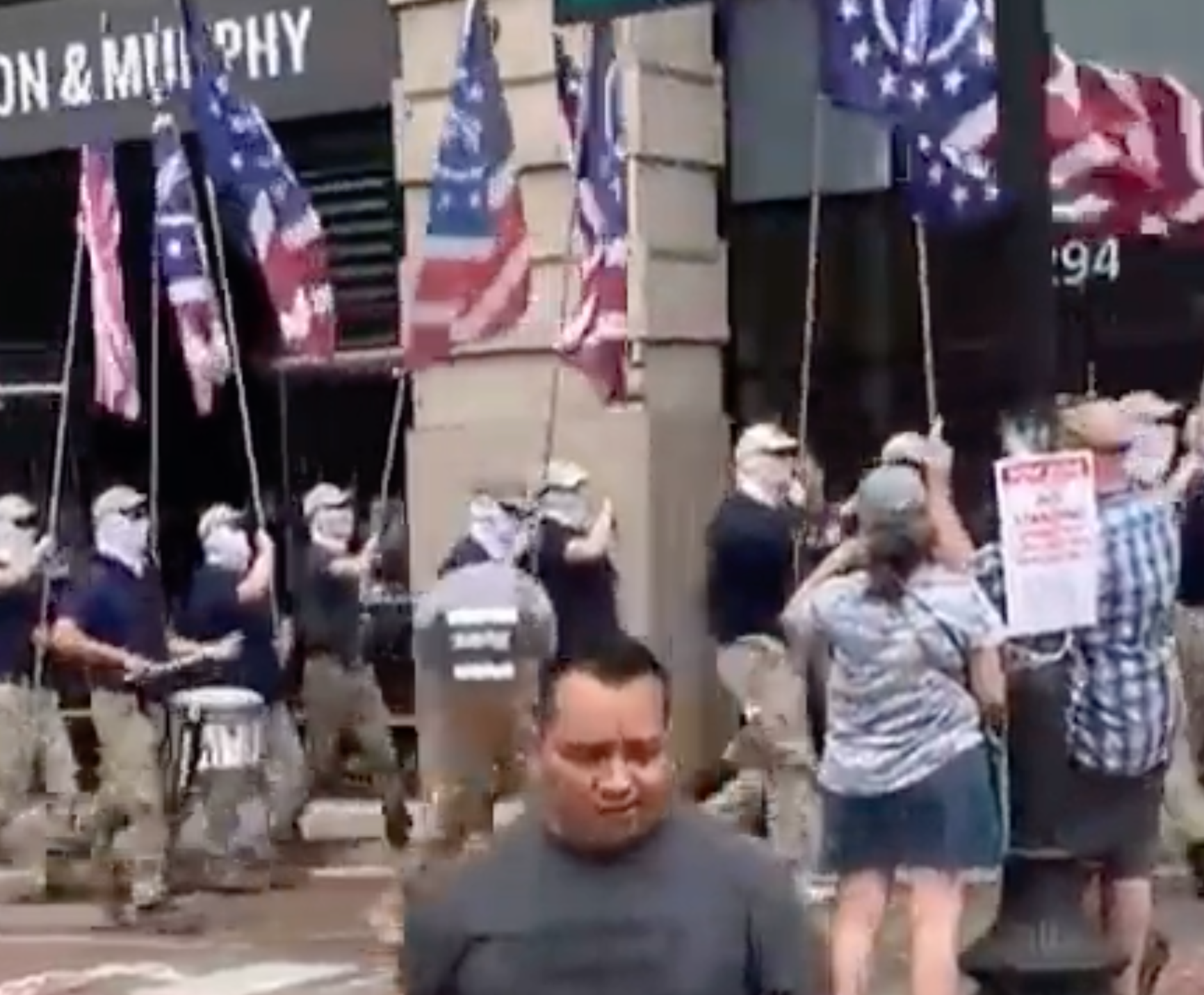 Right-wing extremist group Patriot Front marches through Boston carrying flags. Members of the group have been accused of assaulting a Black man who was trying to film them during their march.