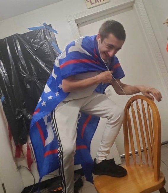 Robert Crimo dressed in a Trump 2020 flag