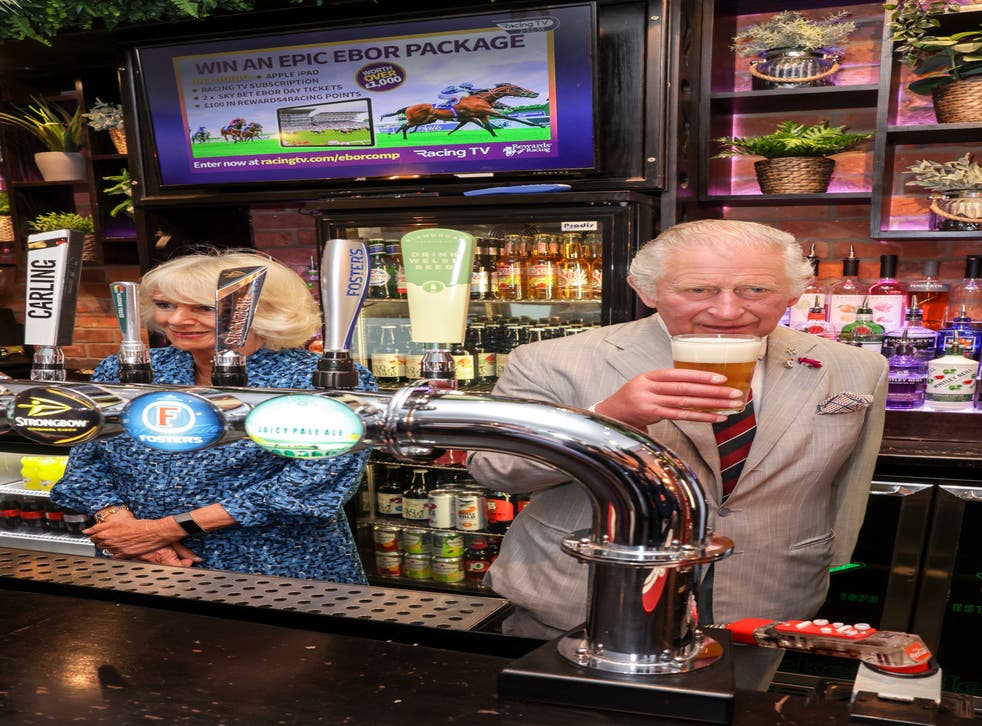 The Prince of Wales behind the bar at The Lion pub (Chris Jackson/PA)