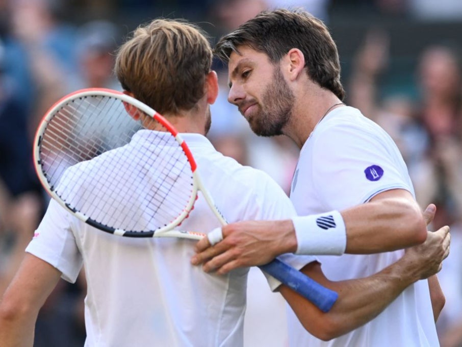 Cameron Norrie and David Goffin embrace at the net after the match