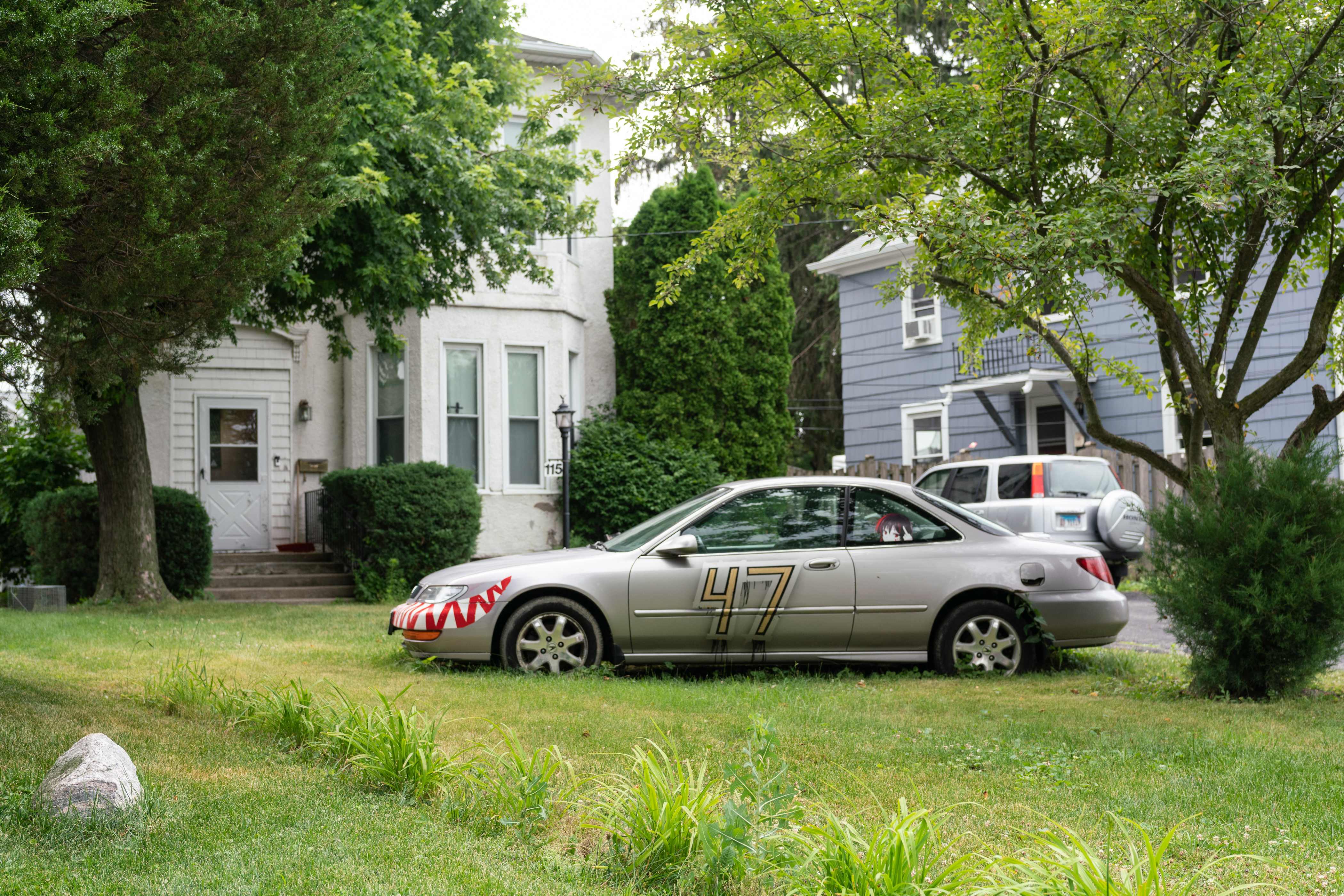 A car with the number 47 is parked outside the home of the suspect