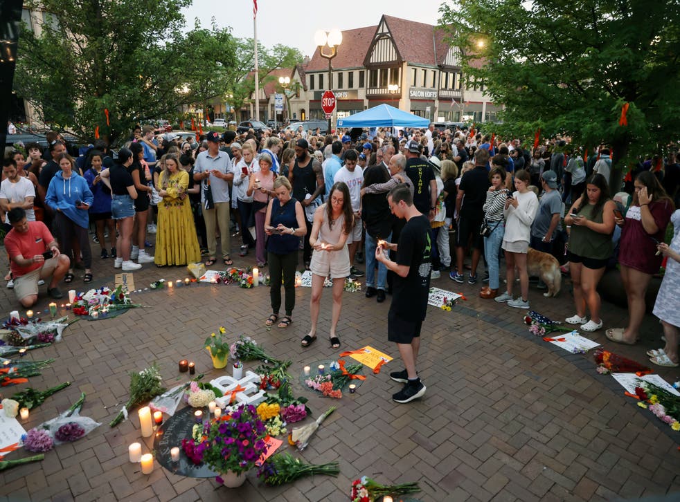 <p>Dozens of mourners gather for a vigil near Central Avenue and St Johns Avenue in downtown Highland Park</p>