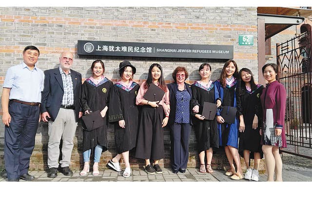 <p>Sonja Mühlberger (fifth from right) and her brother Peter Krips (second from left) with Chen Jian (first left), director of the Shanghai Jewish Refugees Museum, and university students working as volunteers at the museum, in 2019   </p>