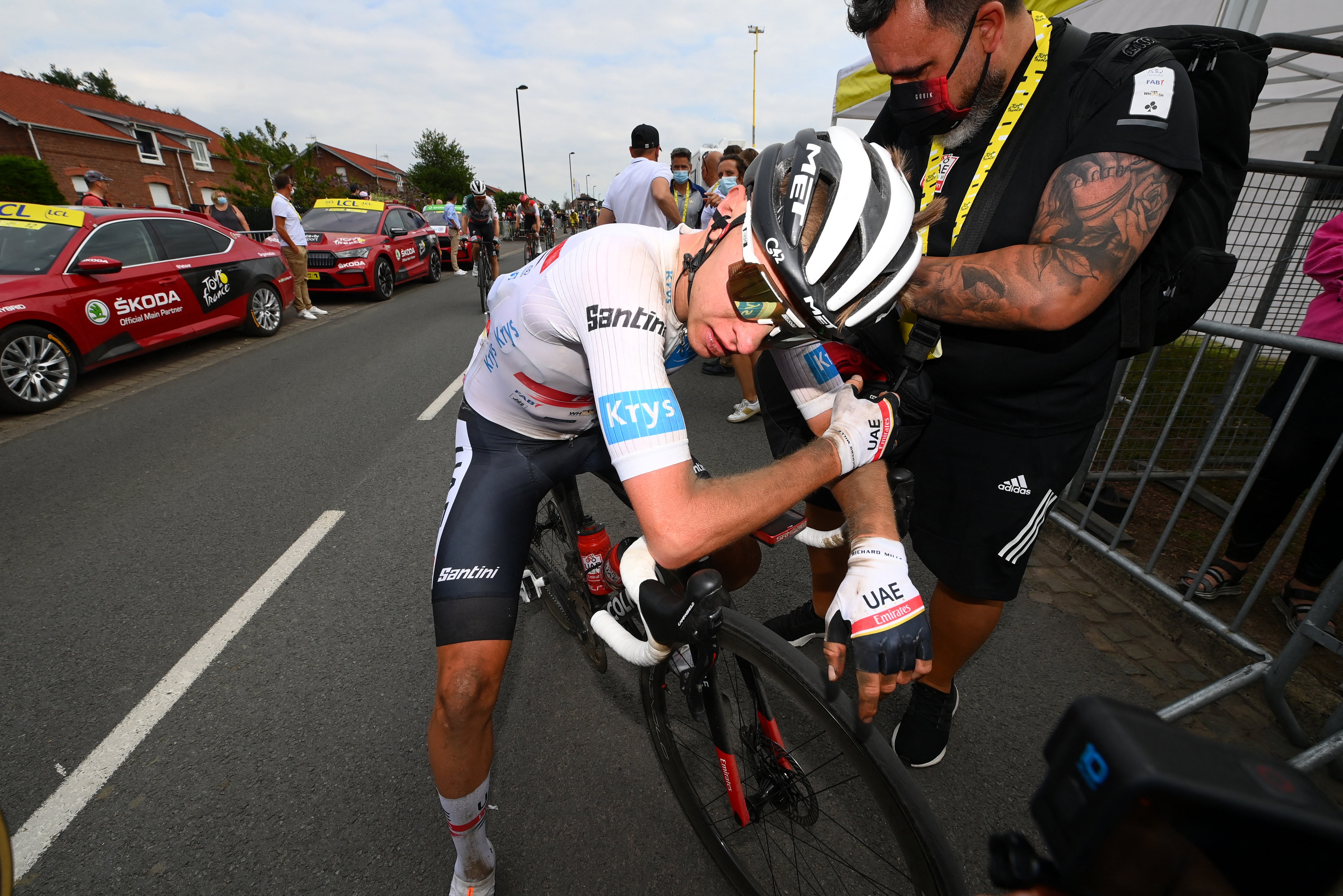 Tadej Pogacar slumps on his handlebars after a brutal stage five