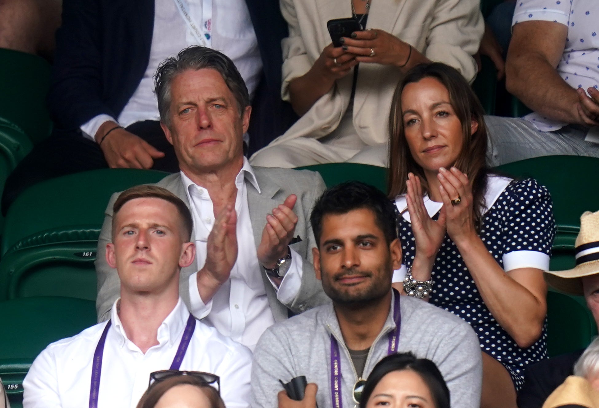Hugh Grant and Anna Elisabet Eberstein clapped along as they watch the action from the sidelines (Adam Davy/PA)