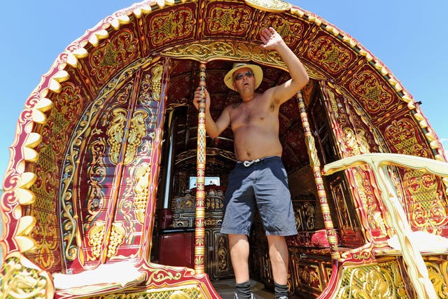 A man pictured on a Romany caravan at the Appleby Horse Fair (Owen Humphreys/PA)