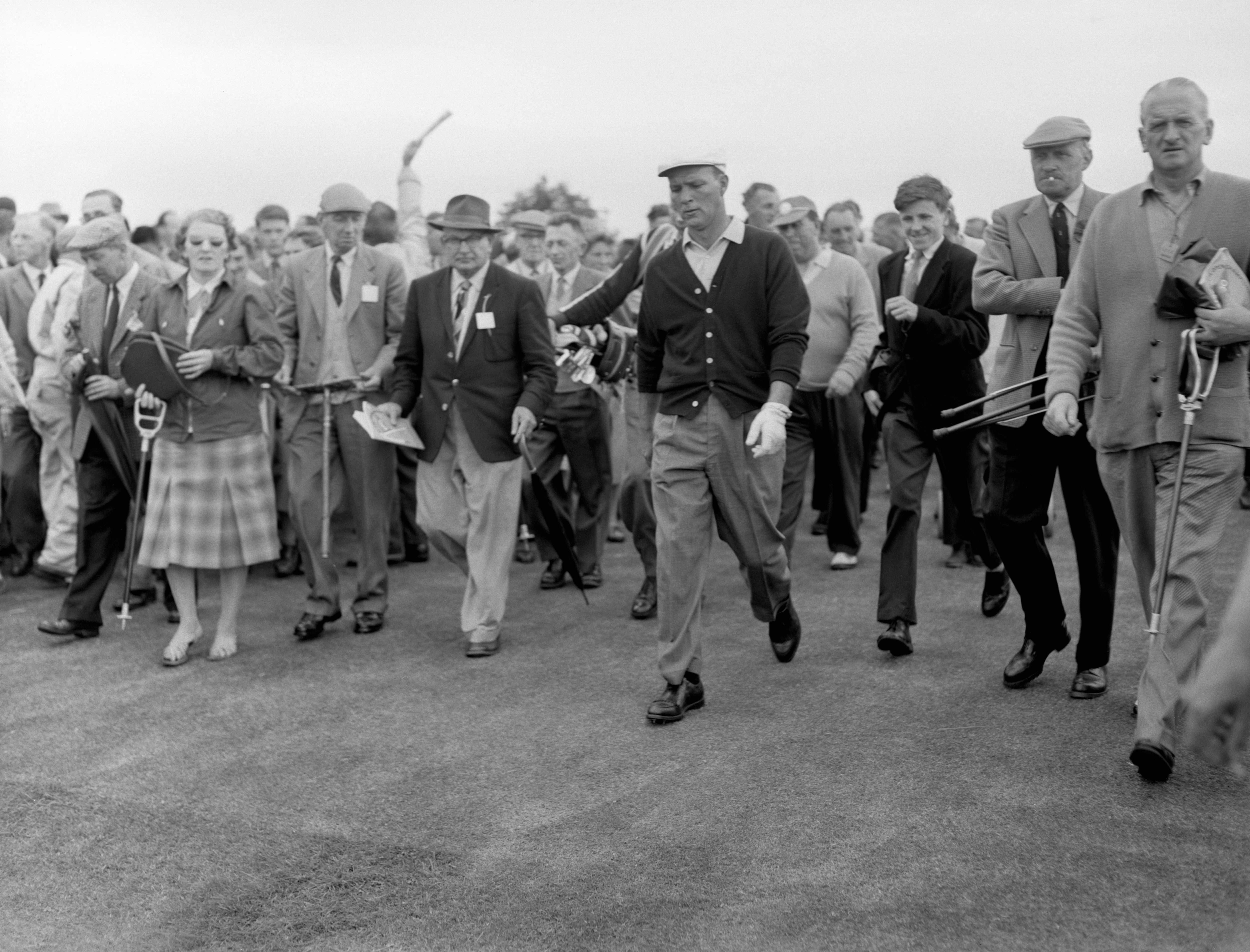 Arnold Palmer followed by spectators during qualifying for the 1960 Open Championship (PA Archive)