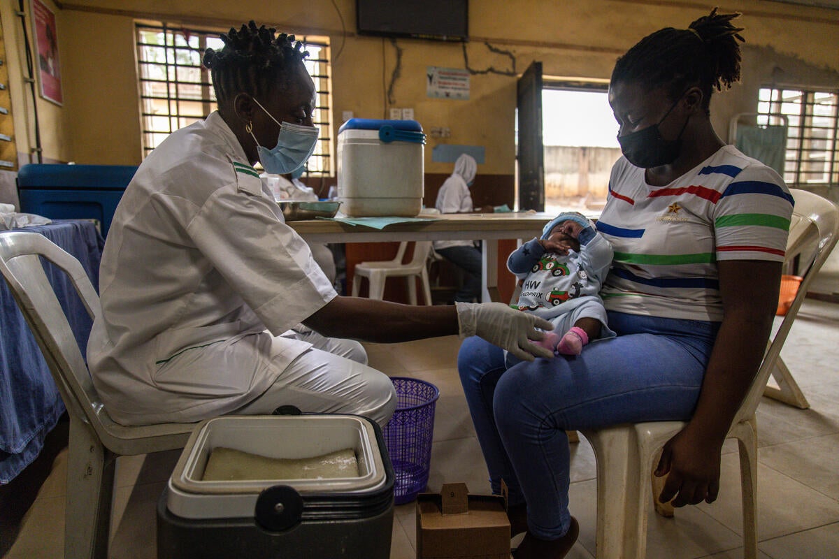 Chief nursing officer Olatunji administers a vaccine at the Ita Elewa health centre in Ikorodu