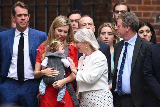 <p>Moments before her husband came out of No 10, she could be seen smiling with their seven-month-old daughter, Romy, in a sling</p>