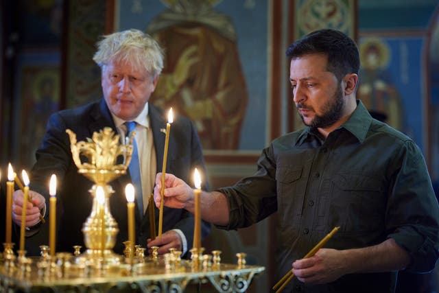 <p>Boris Johnson and Volodymyr Zelensky lighting candles at the St. Mikhailovsky Cathedral in Kyiv last month</p>