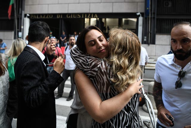 <p>Family members of victims react  after the first hearing of the Morandi bridge collapse trial, outside the courthouse of Genoa on Thursday</p>