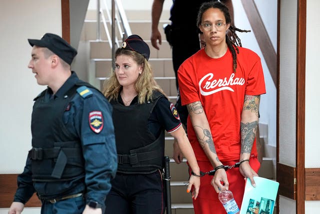 <p>WNBA star and two-time Olympic gold medalist Brittney Griner is escorted to a courtroom for a hearing, in Khimki just outside Moscow, Russia, Thursday, July 7, 2022</p>