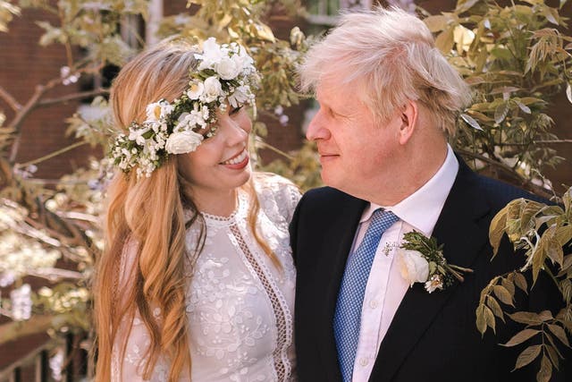 <p> Boris Johnson poses with his wife Carrie Johnson in the garden of 10 Downing Street following their wedding at Westminster Cathedral on May 29, 2021 </p>