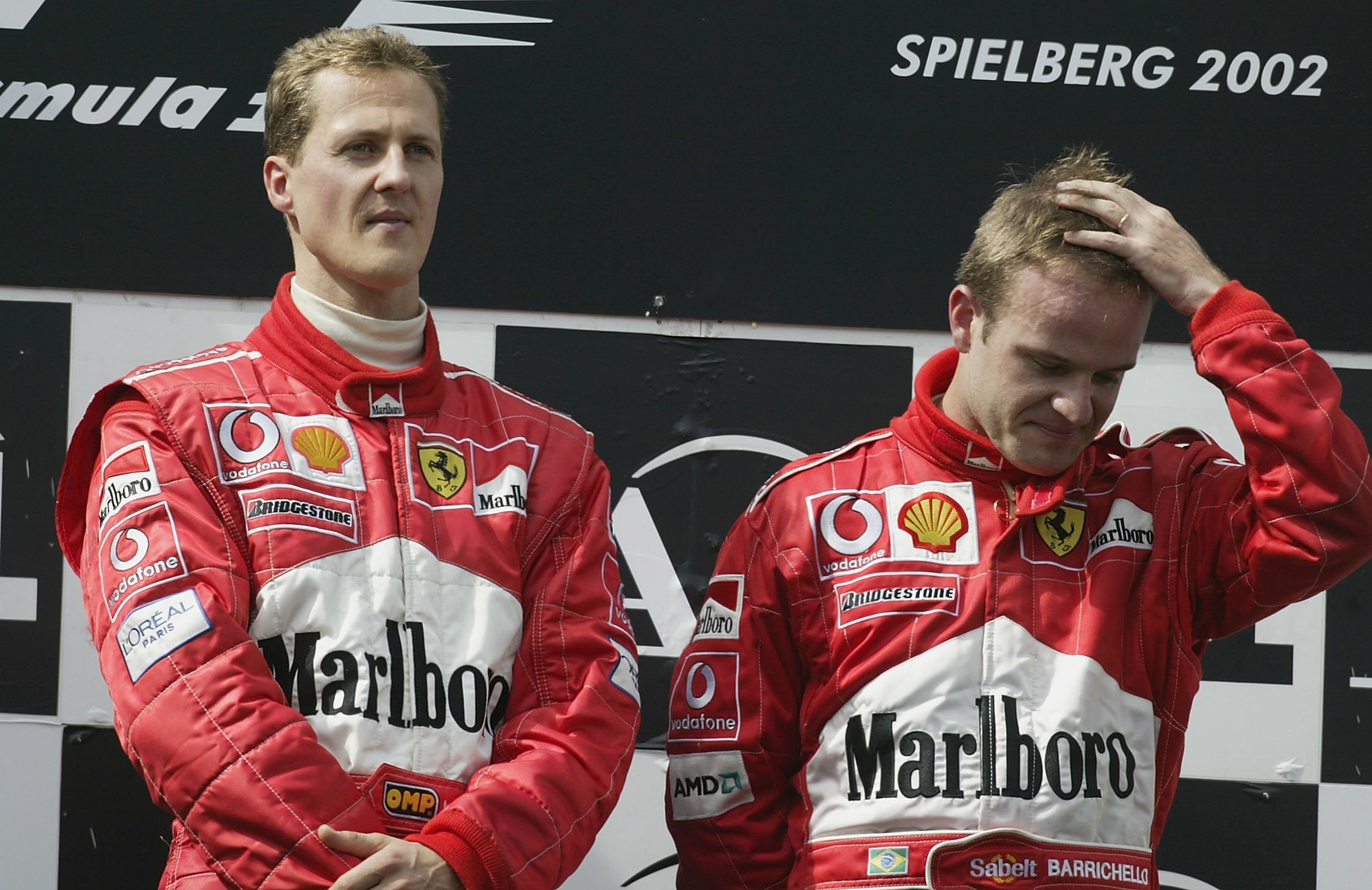 Michael Schumacher, left, and Rubens Barrichello on the podium after the controversial race in 2002