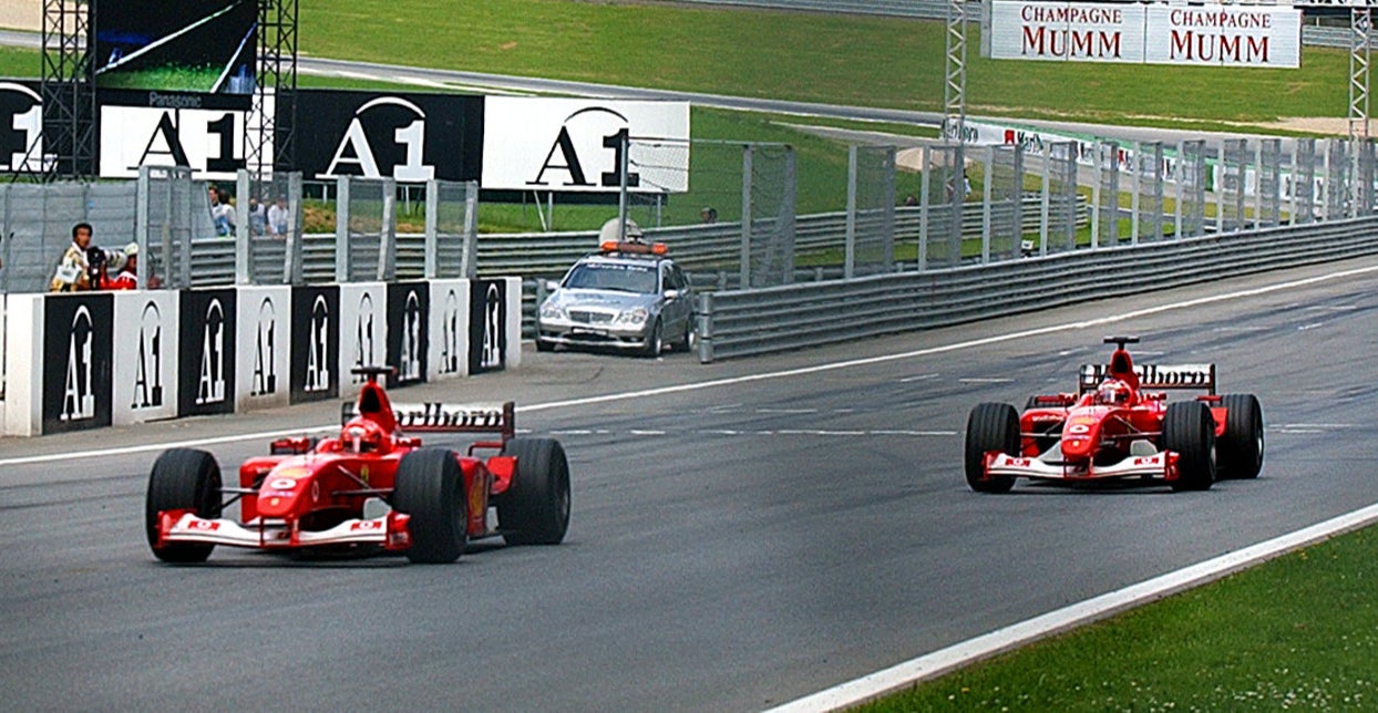 Michael Schumacher crosses the line first after Rubens Barrichello obeyed team orders in 2002
