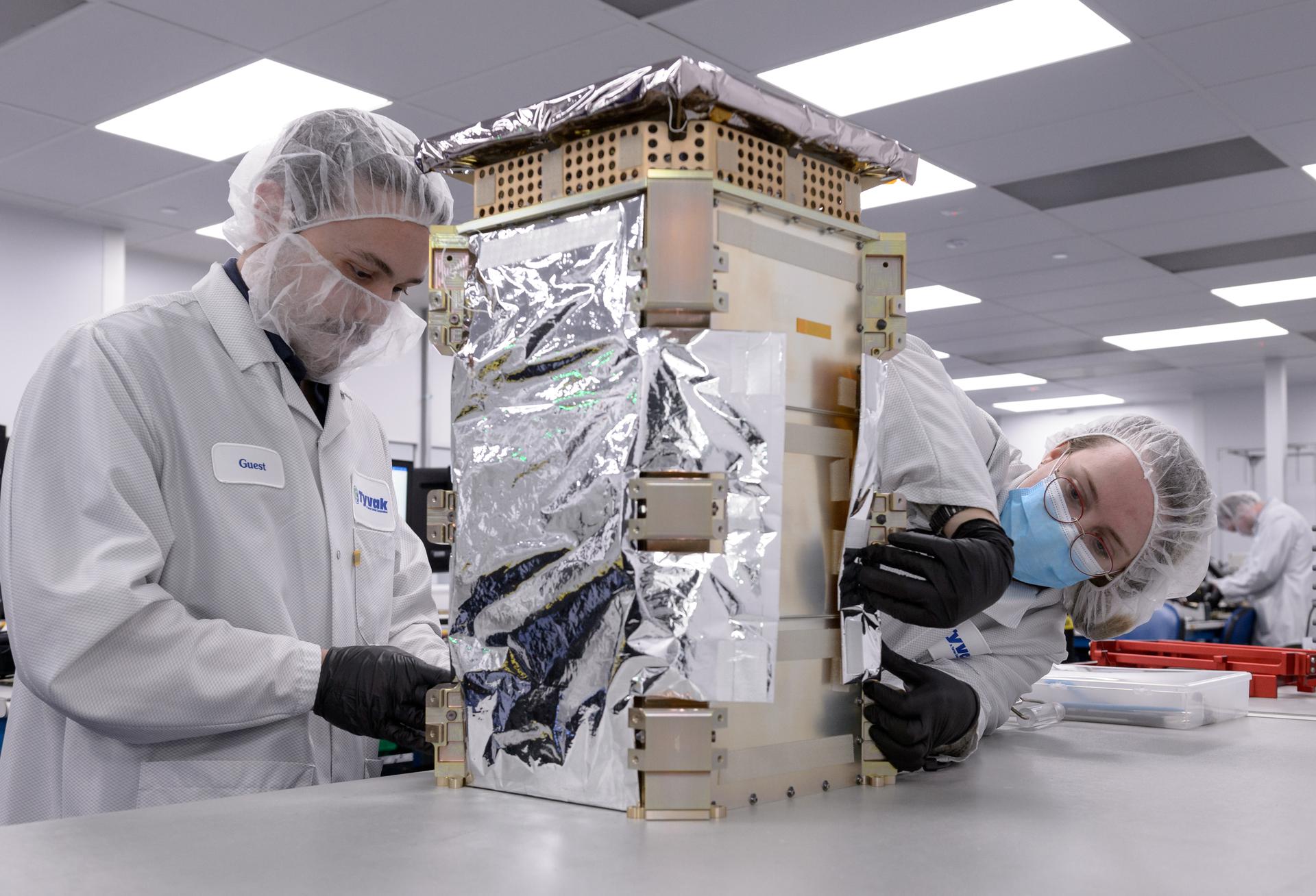 Engineers with Tyvak Nano-Satellite Systems, Inc., in Irvine, California work on Nasa’s Capastone spacecraft prior to launch