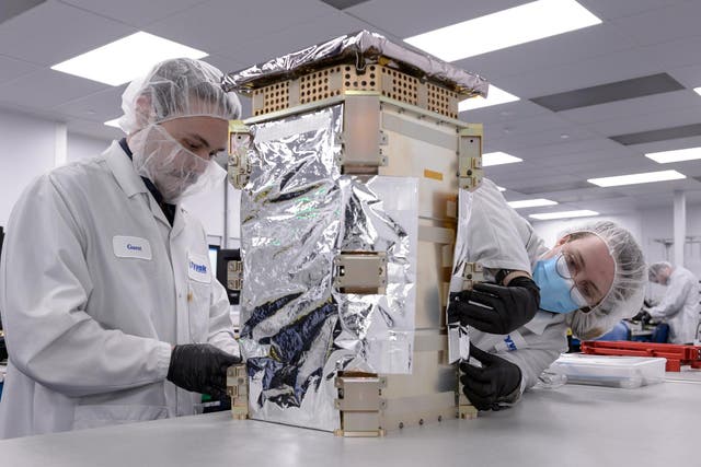 <p>Engineers with Tyvak Nano-Satellite Systems, Inc., in Irvine, California work on Nasa’s Capastone spacecraft prior to launch</p>