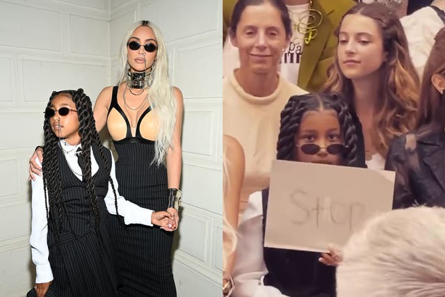 <p>Kim Kardashian’s daughter, North West, holds a sign up to photographers telling them ‘Stop’</p>