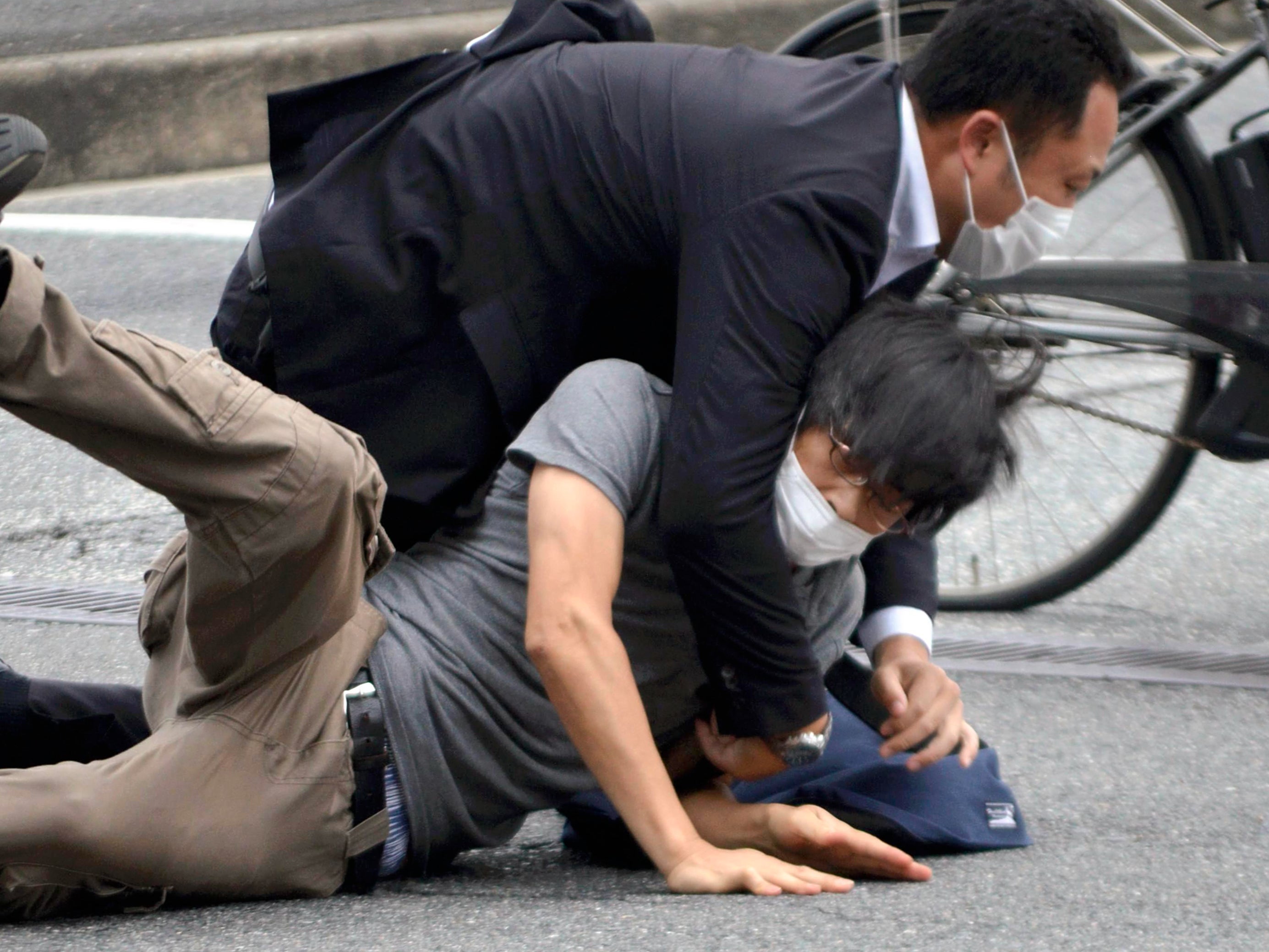 Suspect Tetsuya Yamagami is detained after the shooting of former prime minister Shinzo Abe in Nara Prefecture, western Japan, on Friday, 8 July