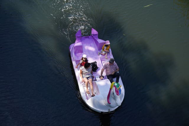 A family use a unicorn-themed pedalo on the river Avon in Warwick (Jacob King/PA)