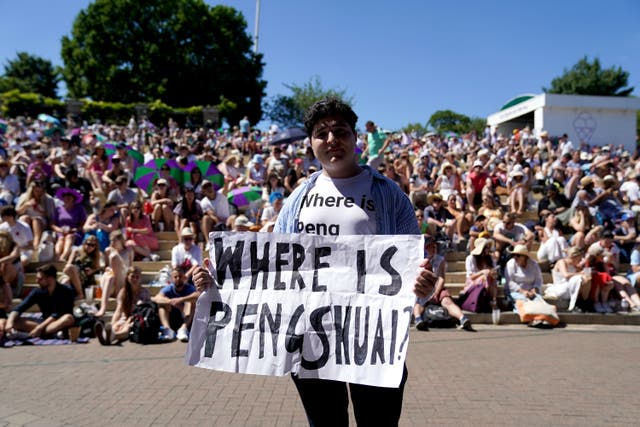 A protester holding a sign and wearing a T-shirt reading ‘where is Peng Shuai’ (PA)