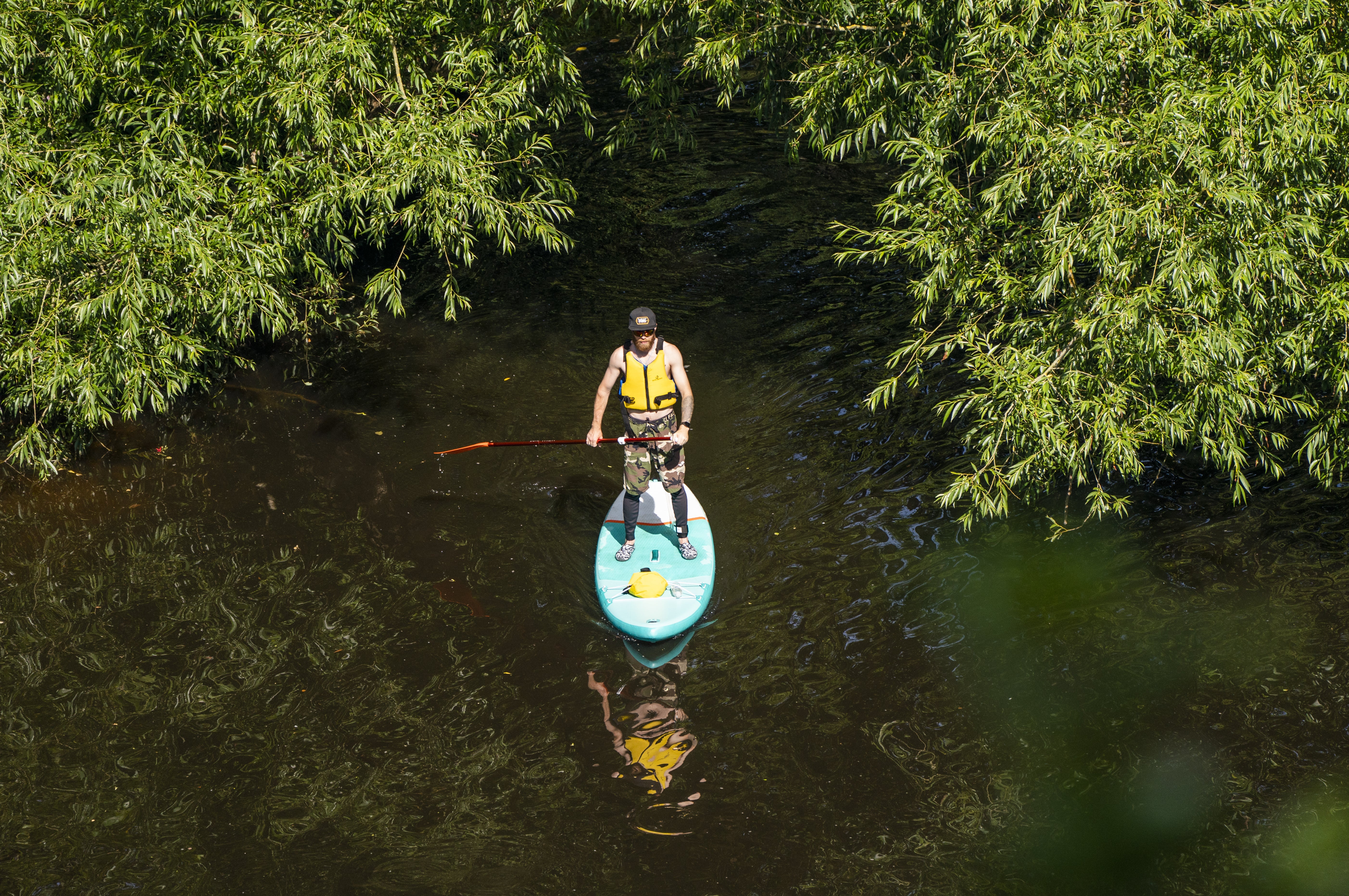 A paddle boarder enjoys the hot weather on the River Nidd in Knaresborough, North Yorkshire (Danny Lawson/PA)