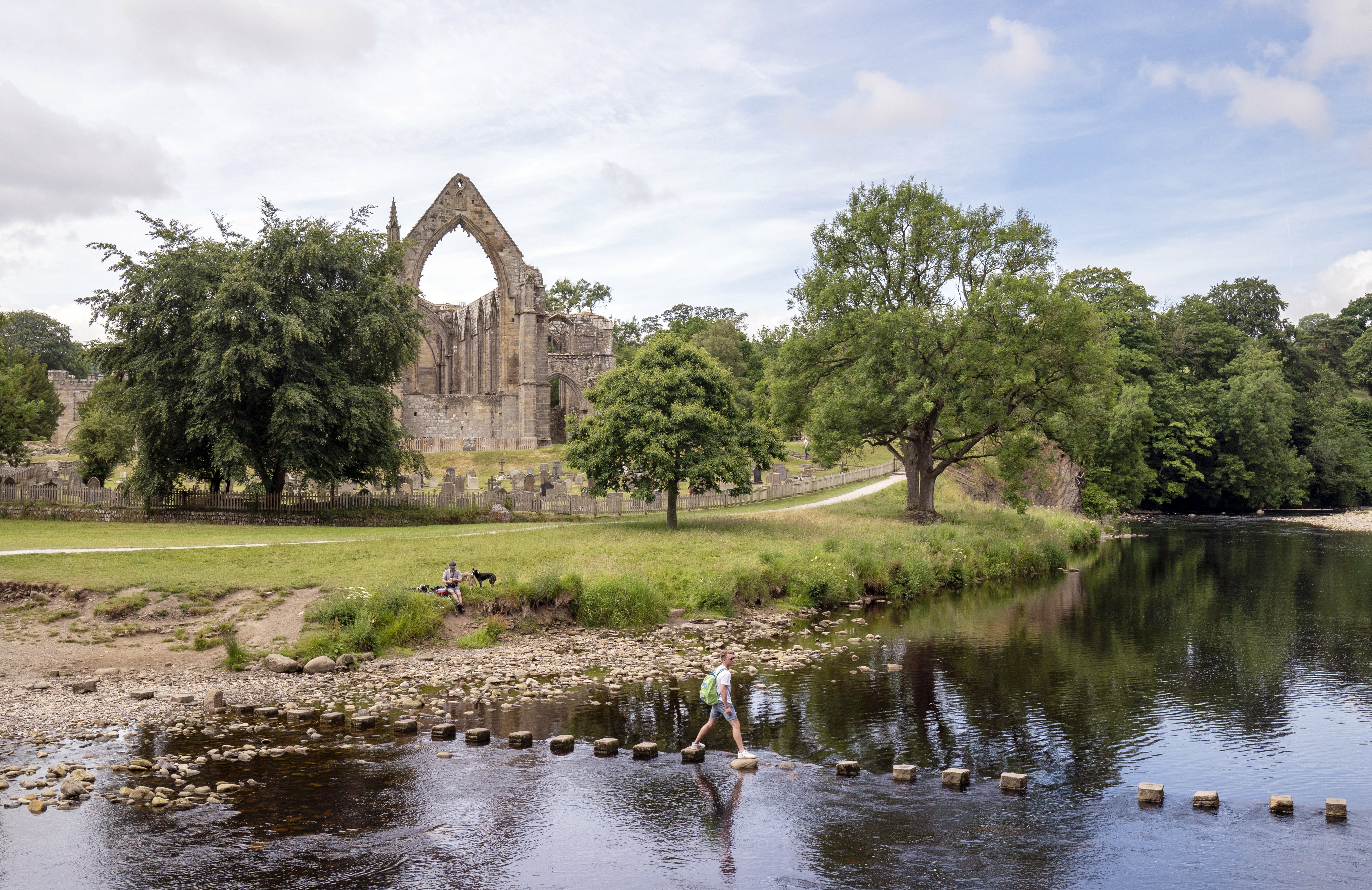 People enjoy the weather at Bolton Abbey in North Yorkshire (Danny Lawson/PA)
