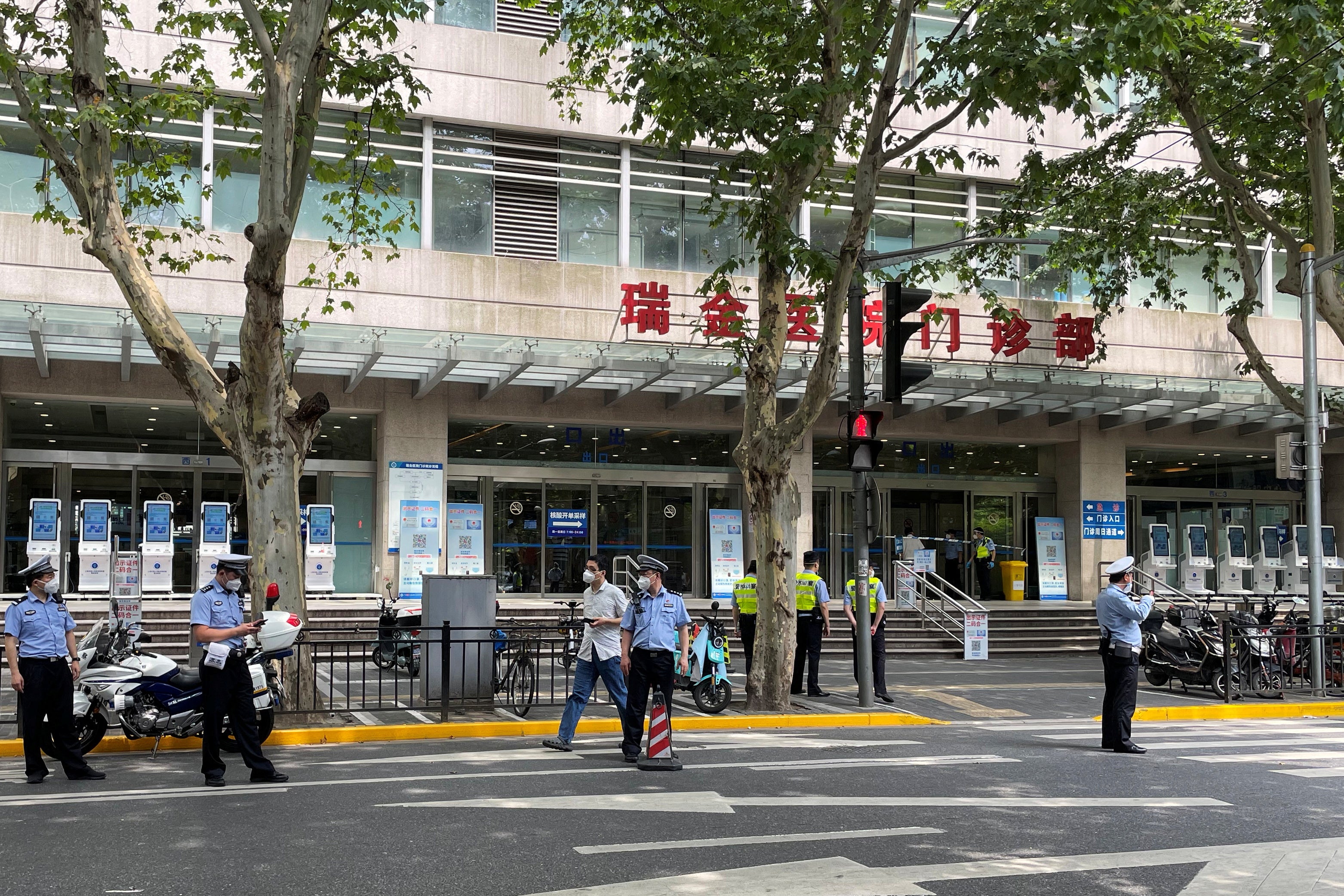 Police officers stand outside Ruijin Hospital following the incident