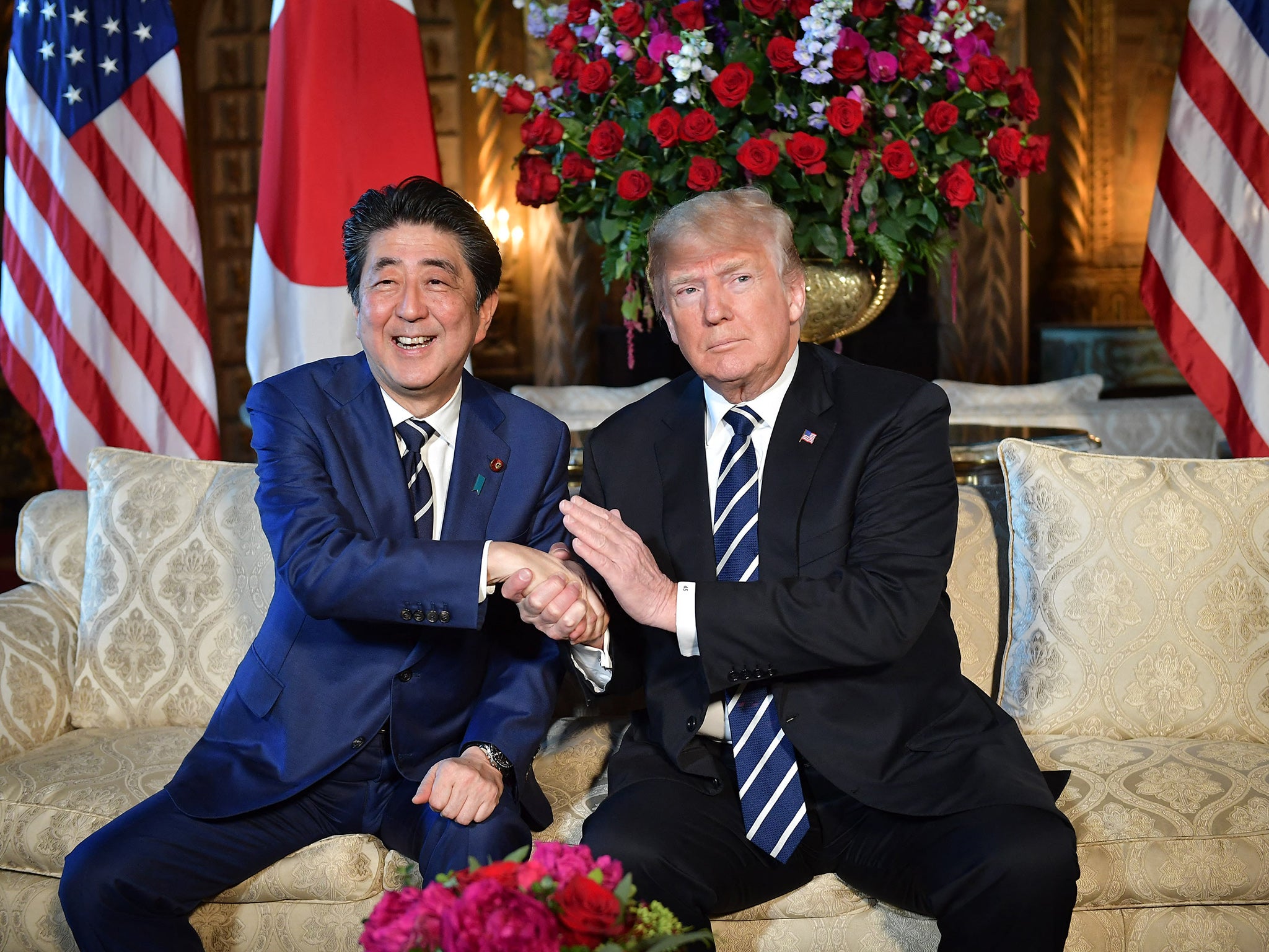 US president Donald Trump greets Abe as he arrives for talks in Palm Beach, Florida, in 2018