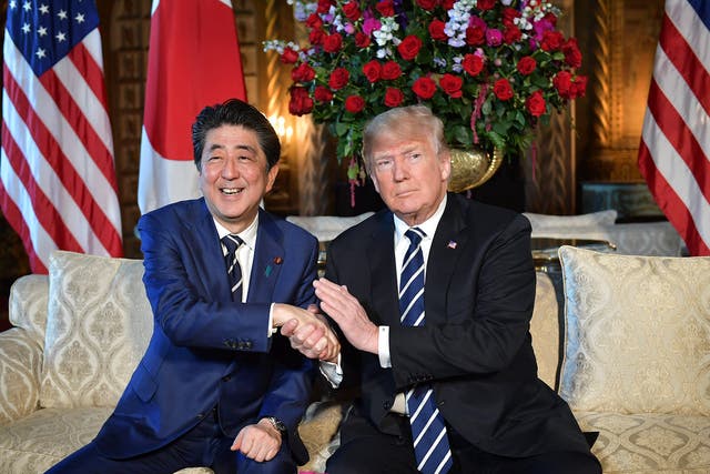 <p>File photo: Donald Trump greets Japanese prime minister Shinzo Abe as he arrives for talks at Mar-a-Lago </p>