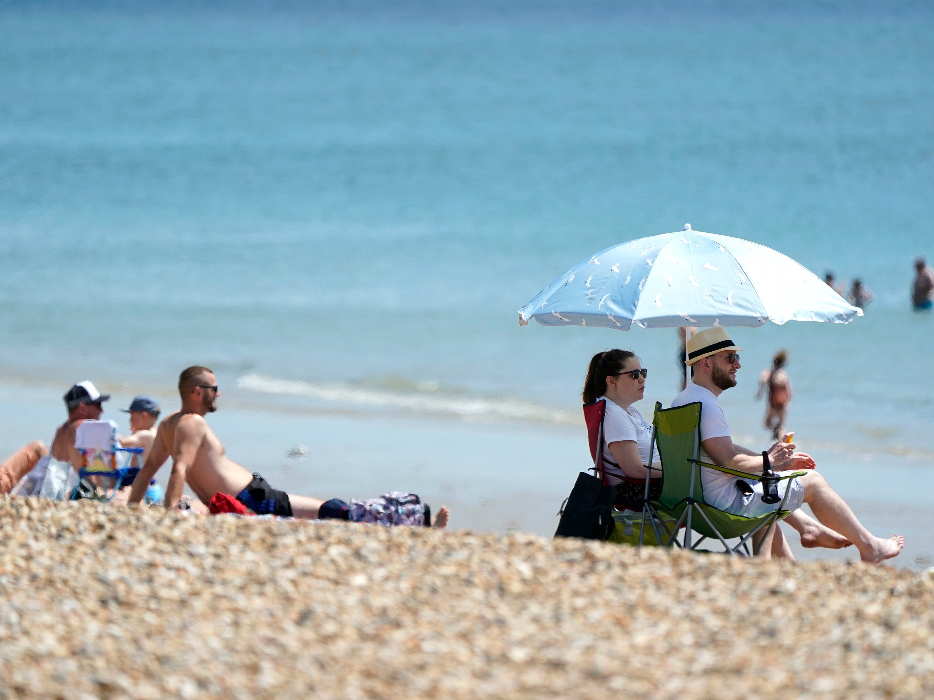 People enjoying the warm weather on Southsea Beach in Hampshire on Saturday