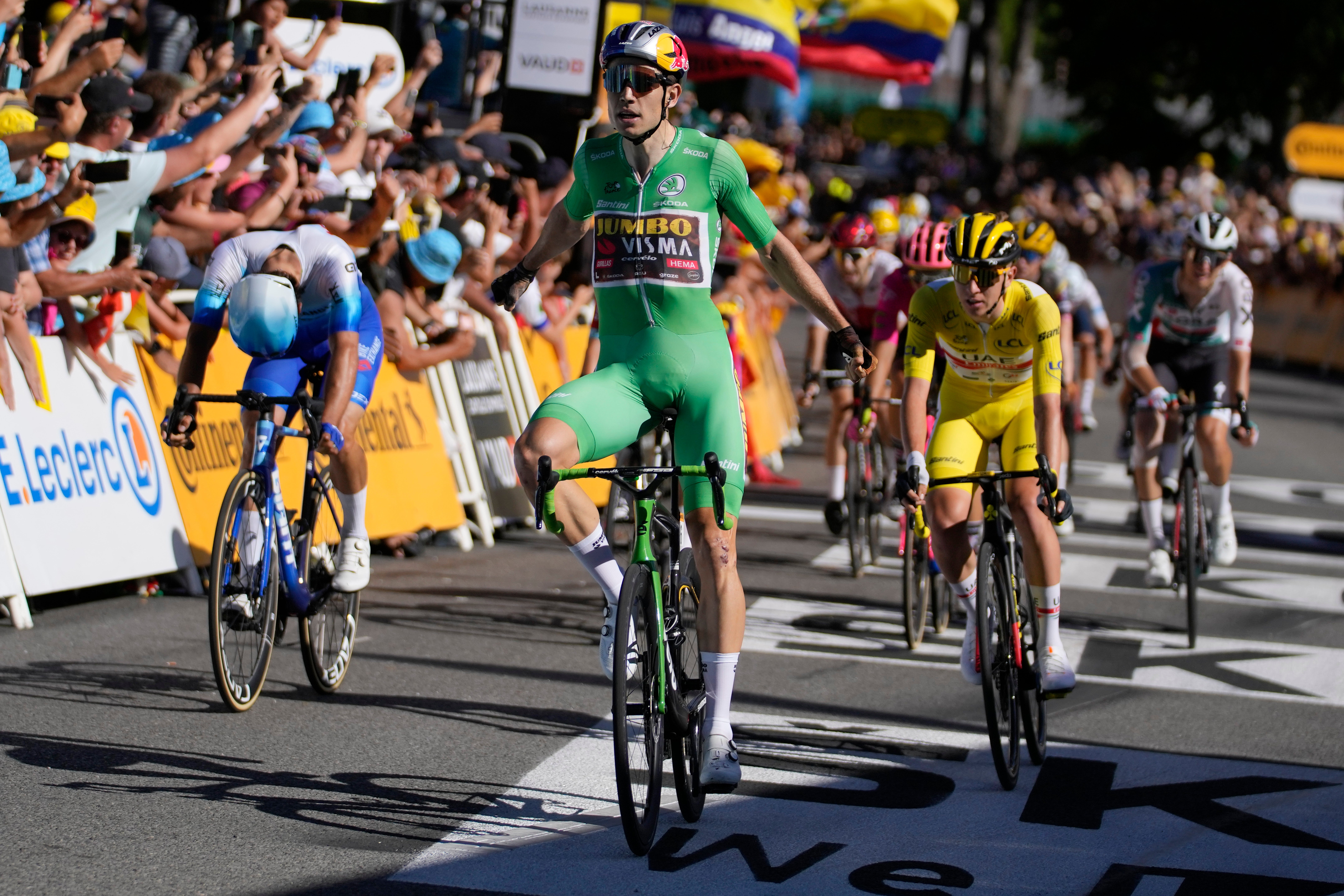 Wout Van Aert took the stage win while Tadej Pogacar was third to extend his lead in yellow (Thibault Camus/AP)