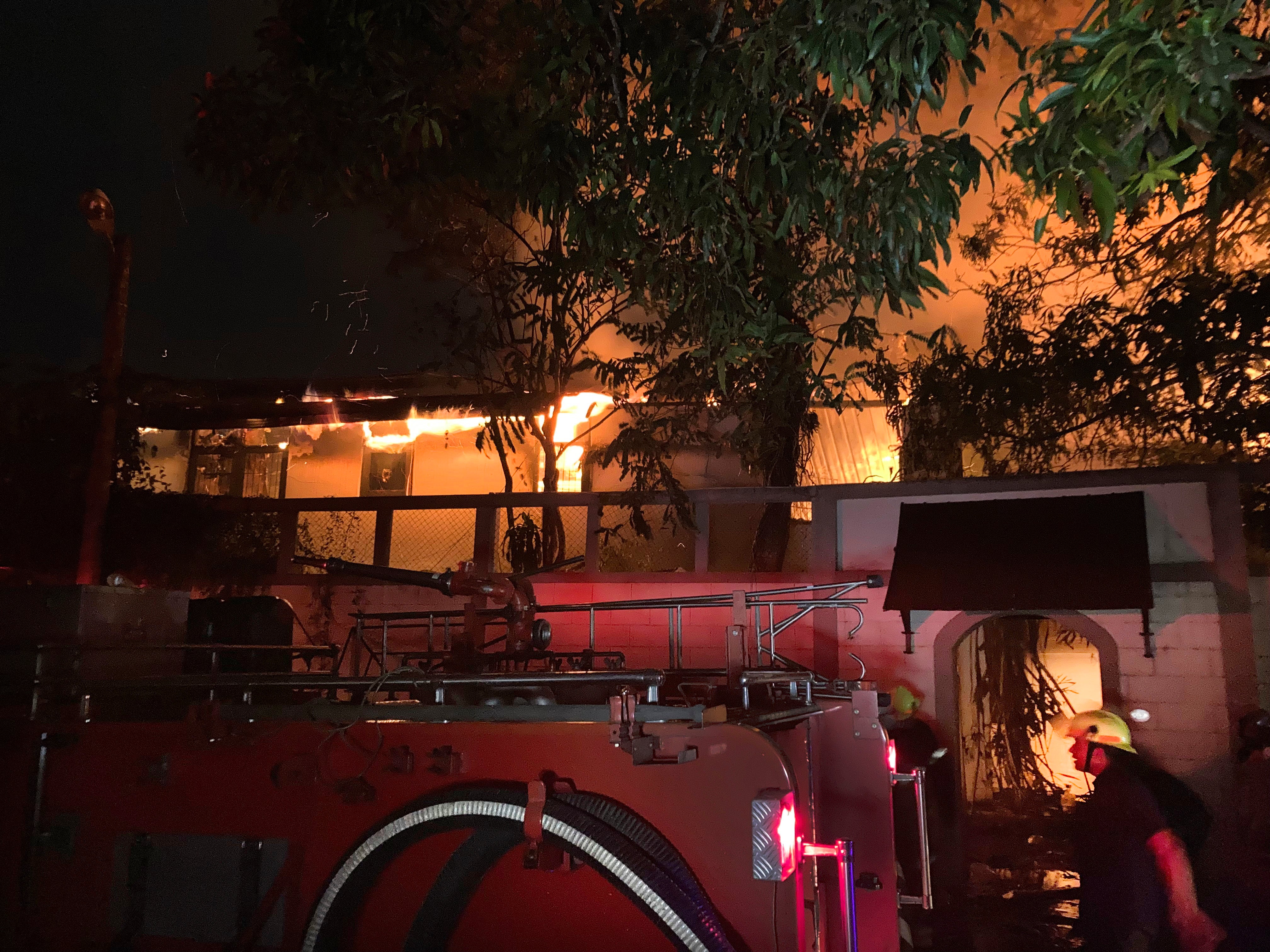 Firefighters try to douse a blaze at Ranil Wickremesinghe’s private residence, in Colombo