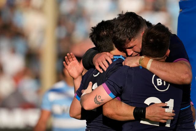 Sam Johnson, left, celebrates with team-mates after scoring Scotland’s fourth try in their victory over Argentina (Natacha Pisarenko/AP)