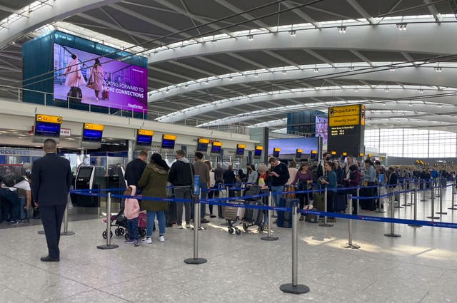 Passengers queue to check-in bags in departures at Terminal 5 of Heathrow Airport, west London (Steve Parsons/PA)